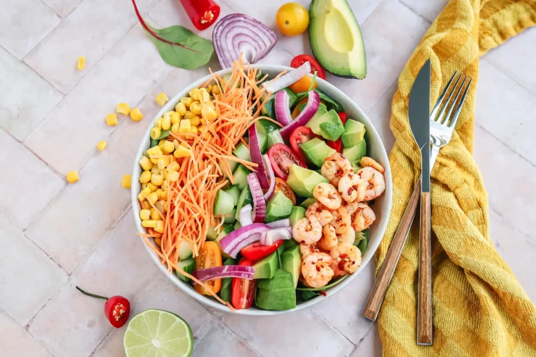 Colorful shrimp salad with corn, avocado, and fresh vegetables