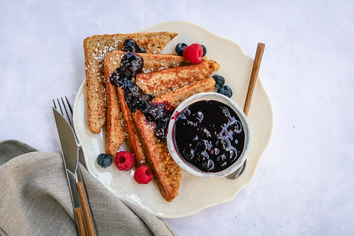 French toast served with warm blueberry sauce and fresh berries