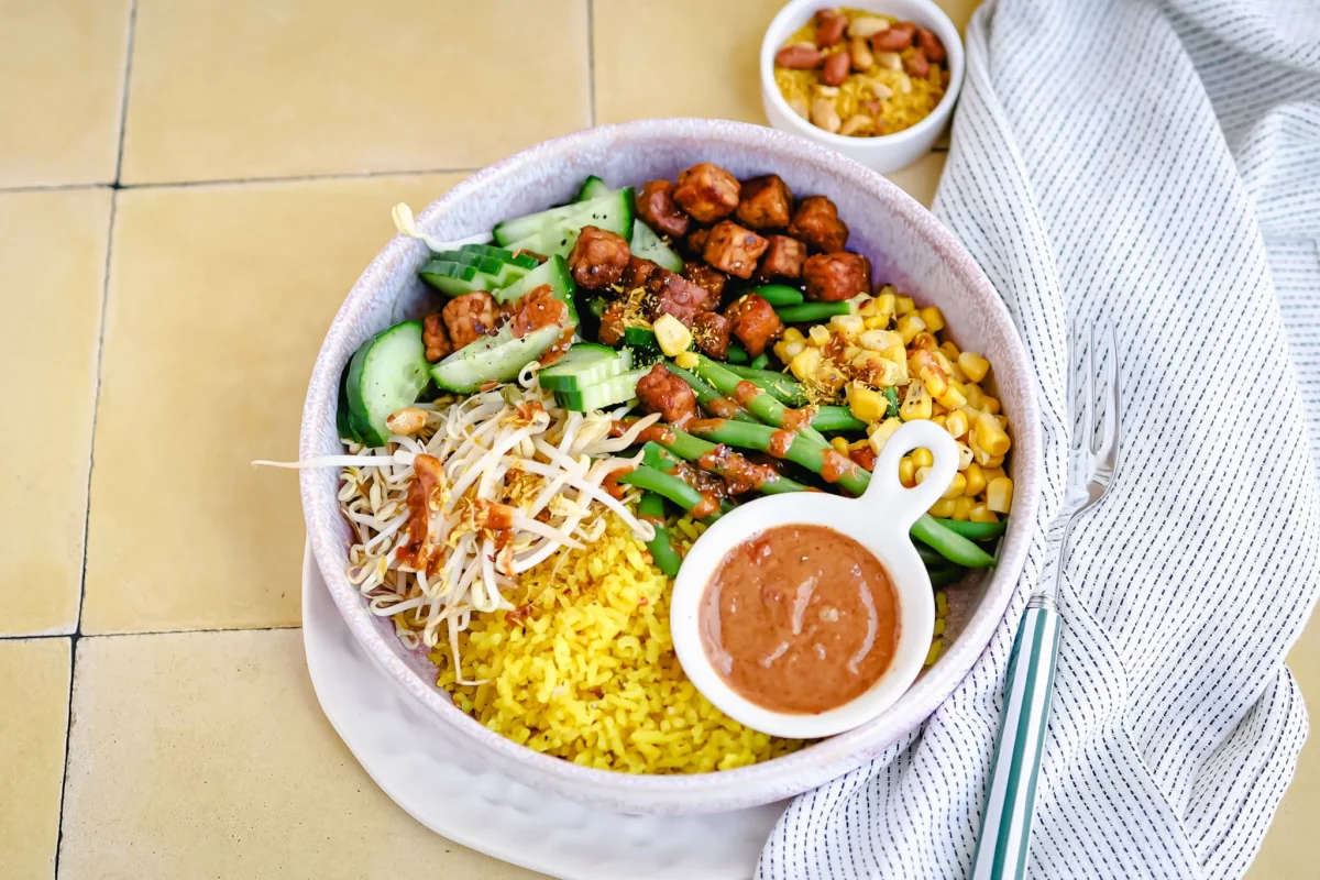 Indonesian gado gado with yellow rice, tempeh, and vegetables