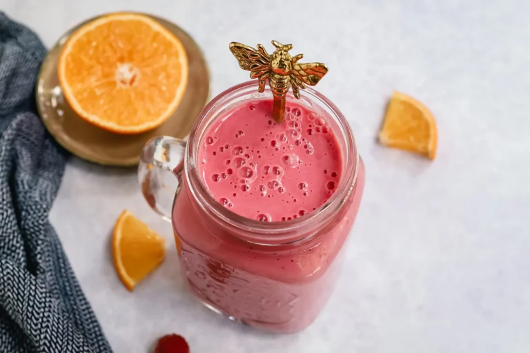 Pink smoothie made with raspberries, yogurt, and orange