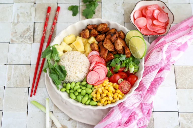 Teriyaki chicken poke bowl with rice, pineapple, and vegetables.
