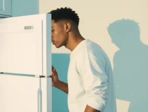 A person in a minimal sunlit kitchen leans into an open refrigerator searching quietly for food in a no decision meals mood.
