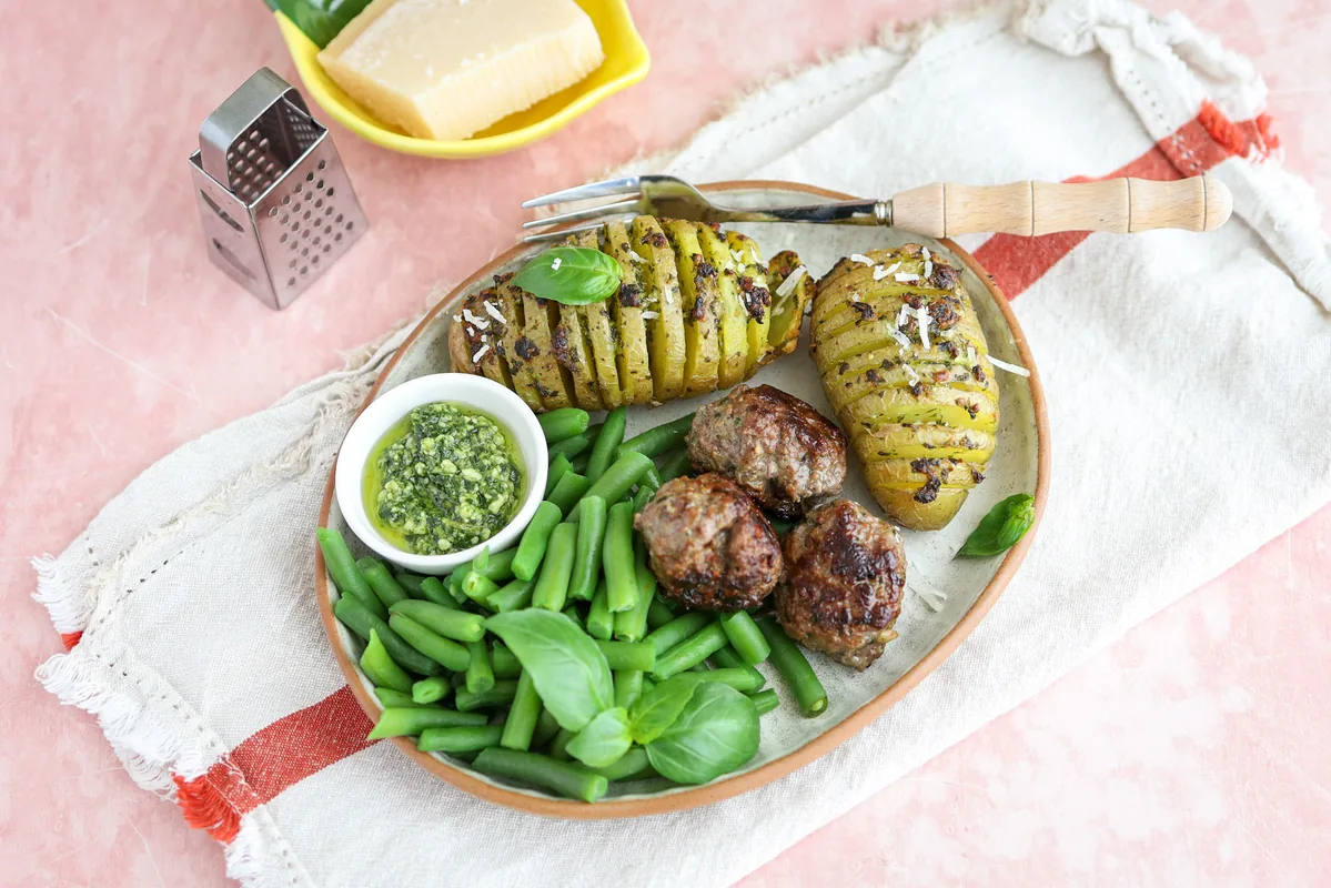 Hasselback Potato with Pesto, Meatballs & Green Beans